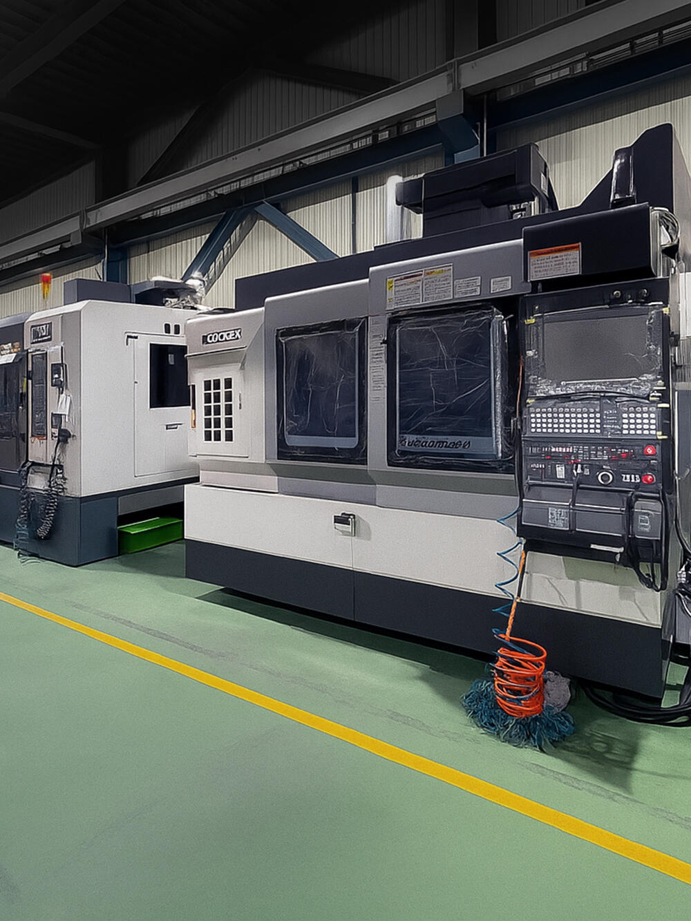 An interior shot of a factory floor featuring two large industrial machines.